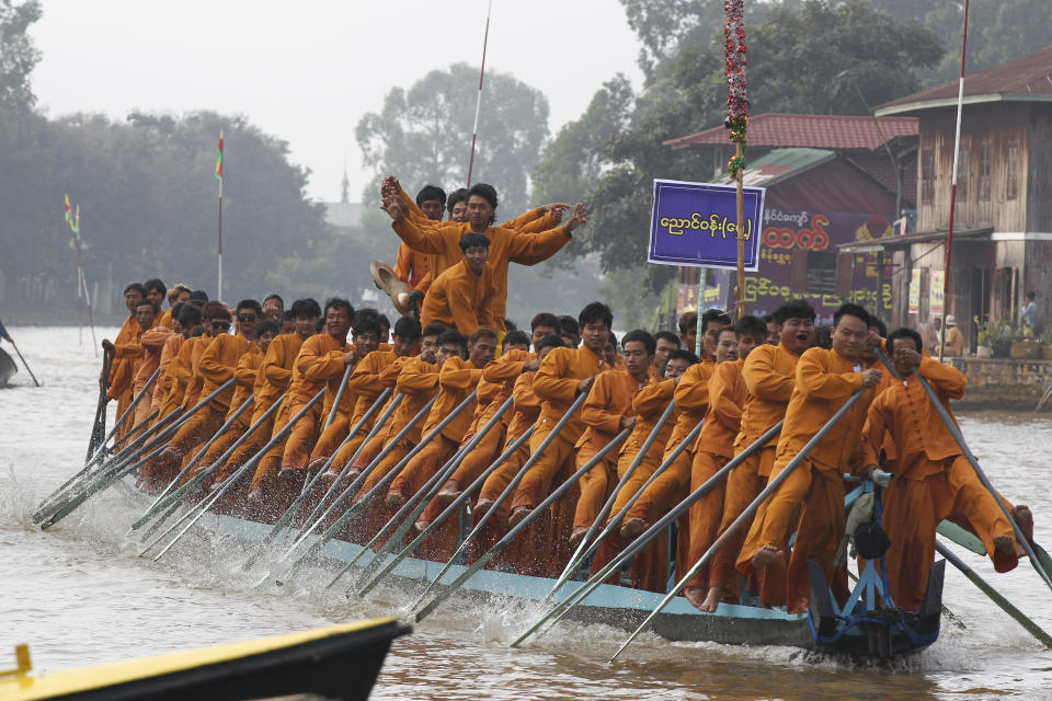 Ethnic Inntha men demonstrate their leg-rowing techniques during a ceremony to mark Inntha National Day Monday, Nov. 13, 2023, in Inle Lake, southern Shan State, Myanmar. (AP Photo/Thein Zaw)