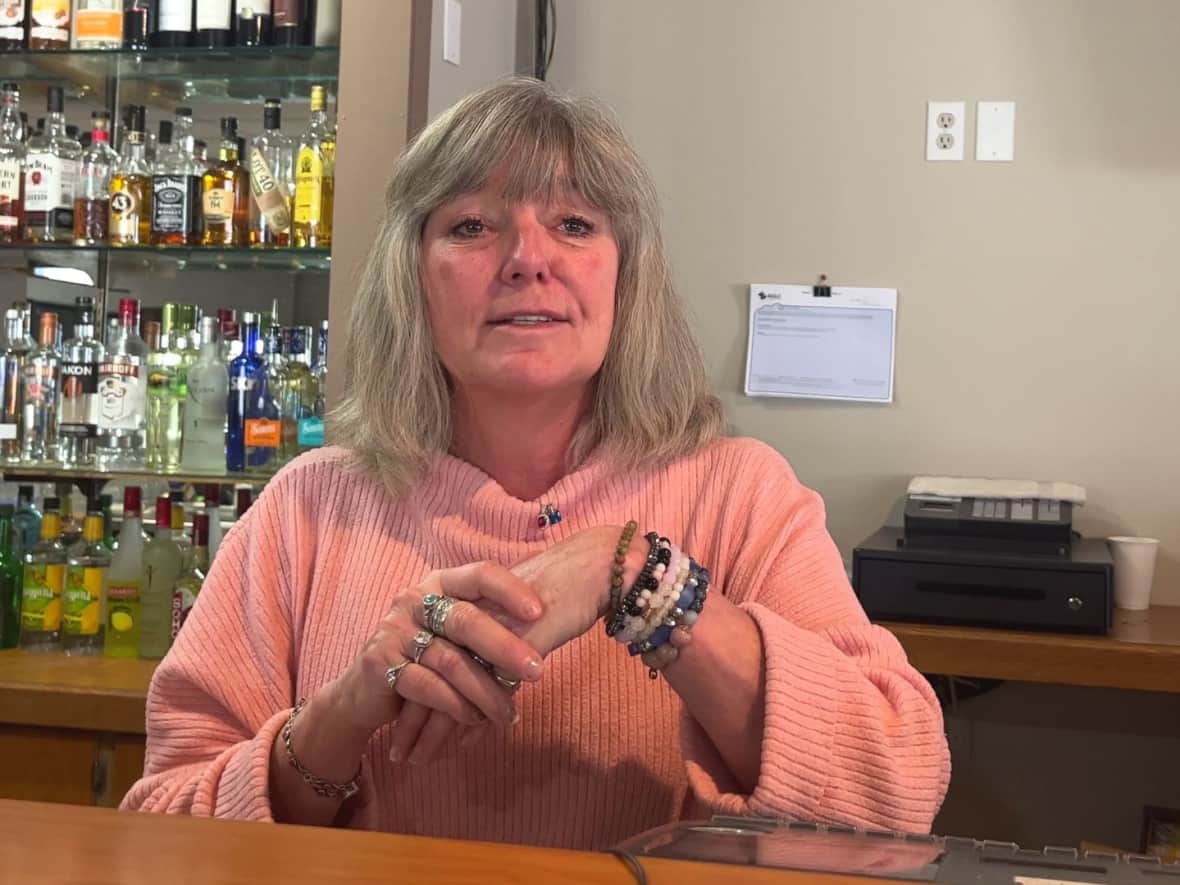 Bartender Brenda Spencer is hoping the oil and gas boom translates into more business in her community of Vulcan, Alta., but it hasn't happened yet. (Joel Dryden/CBC - image credit)