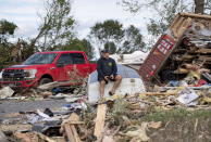 <p>Brian Lowden sits on an overturned boat in his backyard among debris left by a tornado, in Dunrobin, Ont., west of Ottawa, on Sunday, Sept. 23, 2018. The storm tore roofs off of homes, overturned cars and felled power lines in the Ottawa community of Dunrobin and in Gatineau, Que. (Photo from Justin Tang/The Canadian Press) </p>