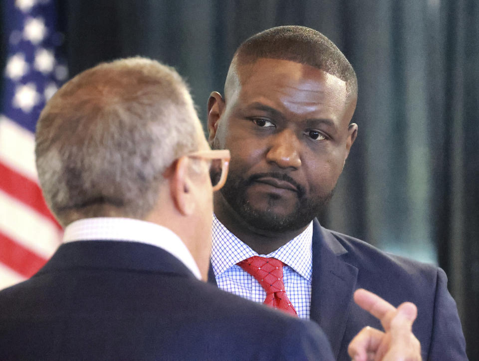 FILE - Central Florida Tourism Oversight District board administrator Glen Gilzean listens to chairman Martin Garcia, left, during the board's meeting in the headquarters of the former Reedy Creek Improvement District at Walt Disney World in Lake Buena Vista, Fla., Wednesday, Aug. 23, 2023. Since allies of Florida Gov. Ron DeSantis took over Walt Disney World's government earlier this year, more than 30 employees have left the Central Florida Tourism Oversight District, raising concerns that decades of institutional knowledge is departing with them, along with a reputation for well-run government.(Joe Burbank/Orlando Sentinel via AP, File)