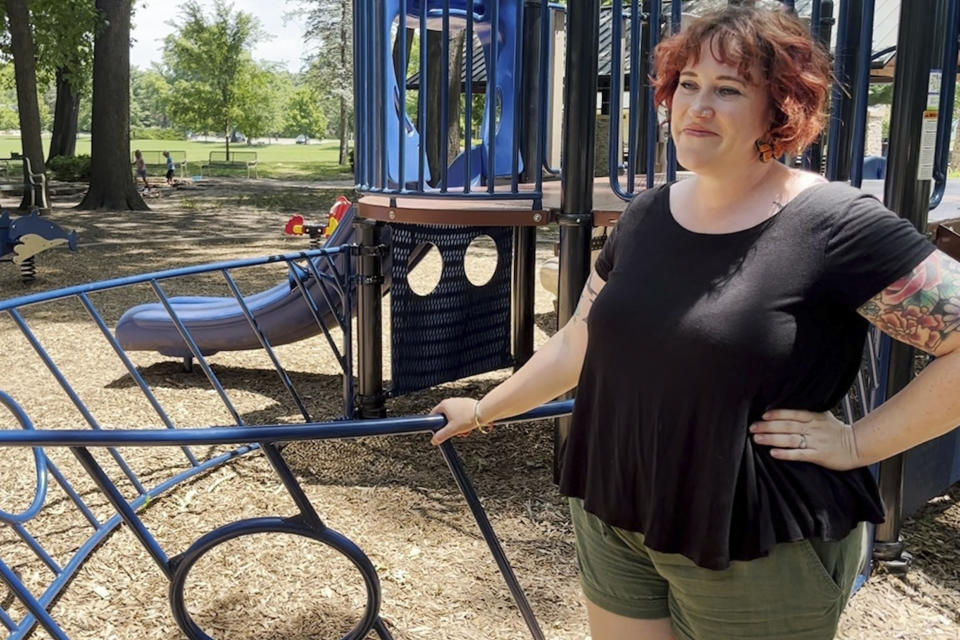Whitney Wilson, a 39-year-old therapist, watches her three children play at a park in the Kansas City suburb of Prairie Village, Kansas, on Friday, June 14, 2024. On Father's Day, she and her wife, Jen Wilson, will pack up their 9-year-old son, 7-year-old daughter and 3-year-old son and take them to visit the sperm donor who made it all possible: David Titterington. To the kids, this-godfather-like figure is alternatively called "bio dad," "donor dad" or "blood father." (AP Photo/Heather Hollingsworth)