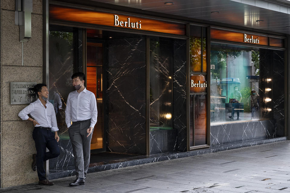 Men having a conversation next to the Berluti store in Hong Kong on Aug. 4, 2021. - Credit: SOPA Images/LightRocket via Gett