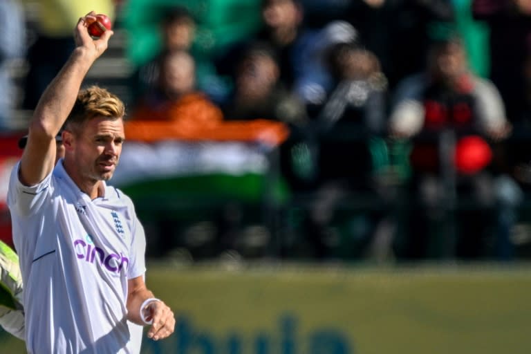 Anderson raised the ball to the crowd against the backdrop of the Himalayas as teammates gathered around him and England fans stood up to cheer (Sajjad HUSSAIN)