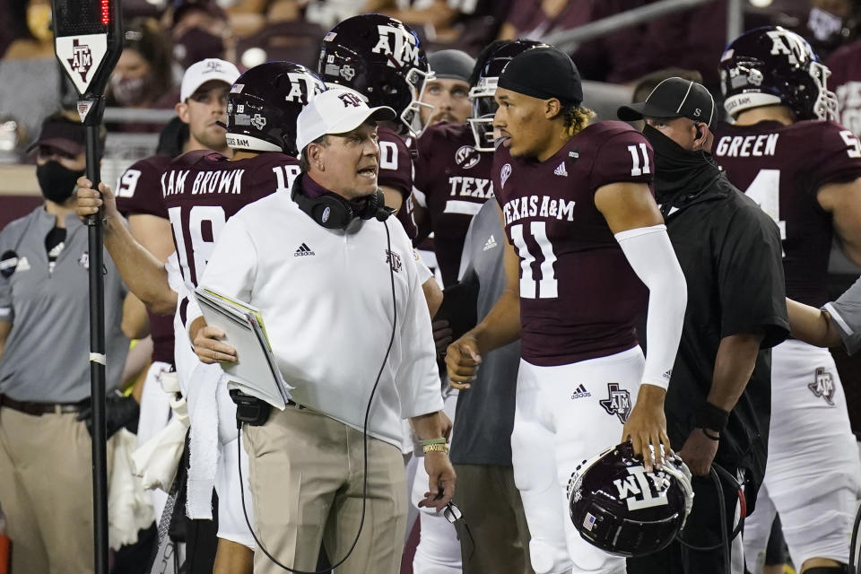 Texas A&M coach Jimbo Fisher, left, talks with quarterback Kellen Mond (11) during the first half of an NCAA college football game against Vanderbilt Saturday, Sept. 26, 2020, in College Station, Texas. (AP Photo/David J. Phillip)