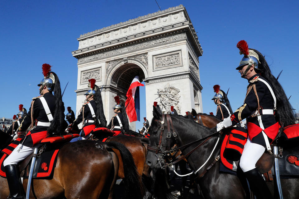 French Republican Guards ride past the Arc de Triomphe