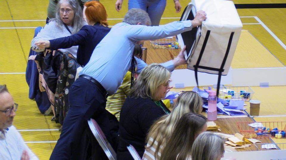 Ballots being dropped onto a table