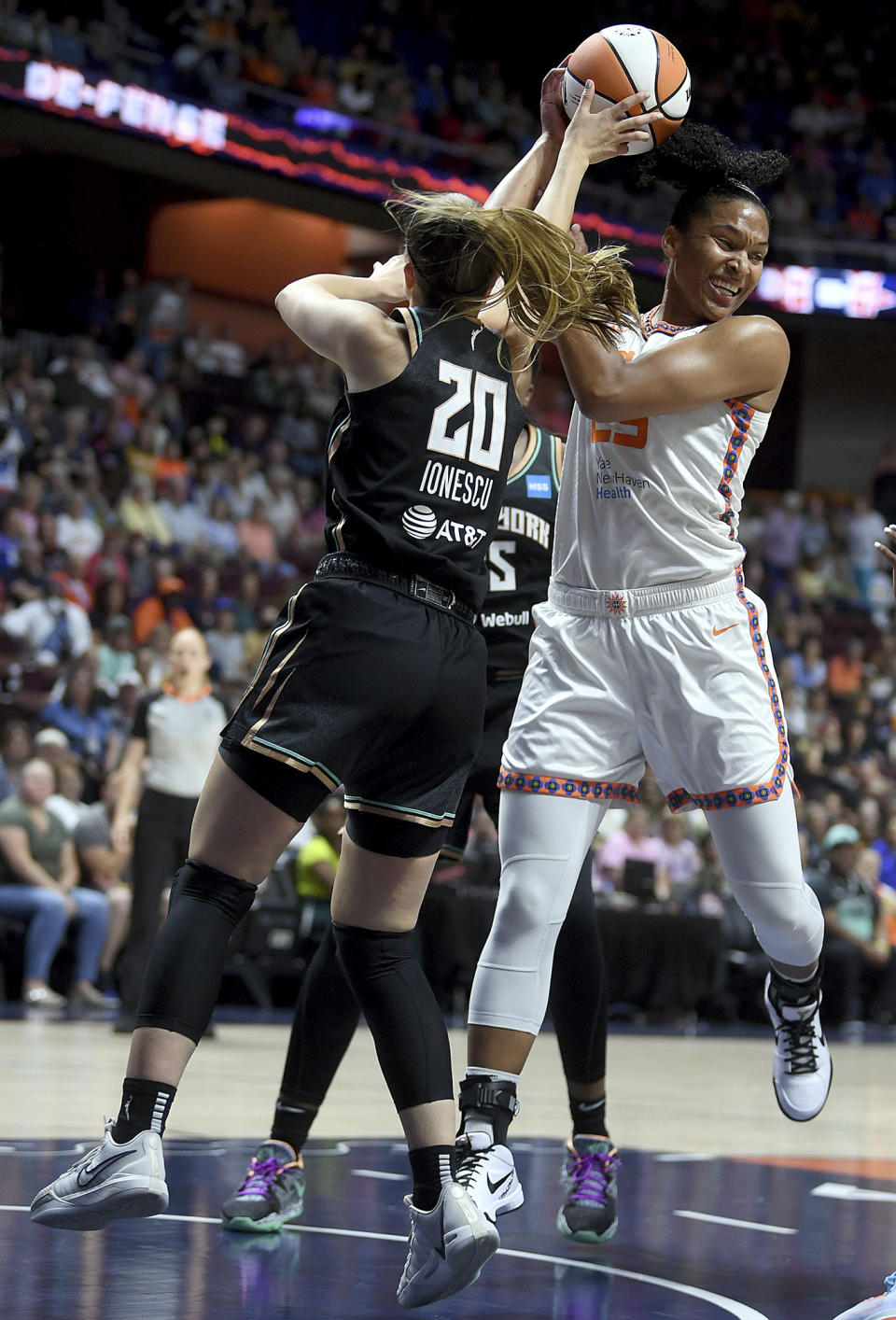 Connecticut Sun's Alyssa Thomas (25) steals a rebound from New York Liberty's Sabrina Ionescu (20) during the first half of a WNBA basketball game, Tuesday, June 27, 2023 at Mohegan Sun Arena in Uncasville, Conn. (Sarah Gordon/The Day via AP)