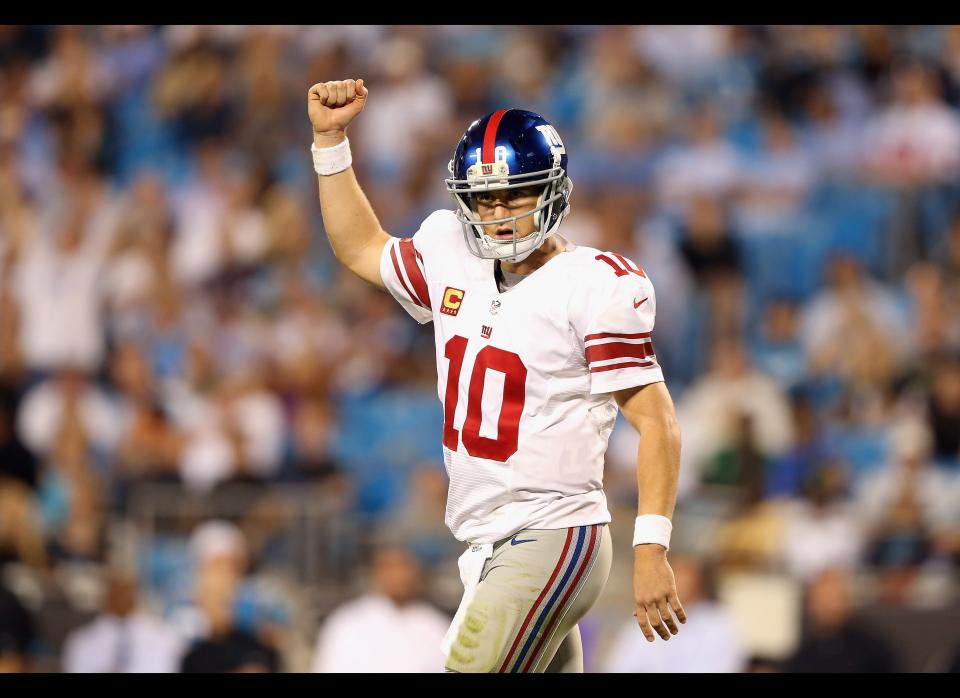 Eli Manning #10 of the New York Giants celebrates after a touchdown against the Carolina Panthers during their game at Bank of America Stadium on September 20, 2012 in Charlotte, North Carolina.