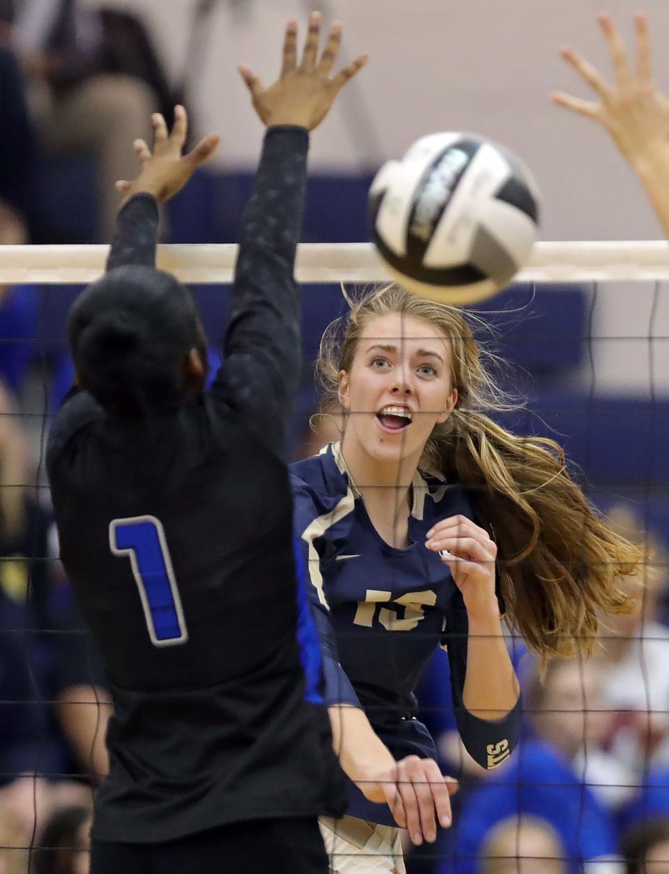 Hoban sophomore Amber Watson hits the ball past CVCA sophomore McKenzie Neal during the first set of a Division II district semifinal volleyball match, Wednesday, Oct. 26, 2022, in Tallmadge, Ohio.