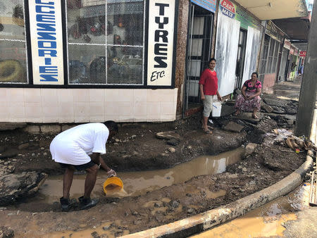 A man collects water, after flooding from Tropical Cyclone Josie in Ba, Fiji April 2, 2018 in this image obtained from social media. Naziah Ali via REUTERS