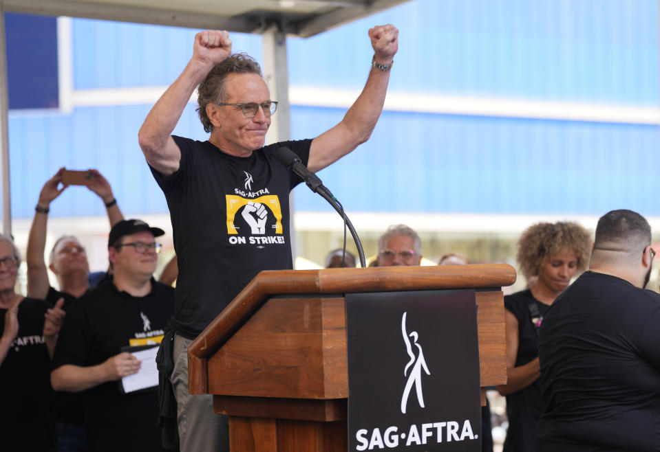 Actor Bryan Cranston speaks during the SAG-AFTRA "Rock the City for a Fair Contract" rally in Times Square on Tuesday, July 25, 2023, in New York. The actors strike comes more than two months after screenwriters began striking in their bid to get better pay and working conditions. (Photo by Charles Sykes/Invision/AP)