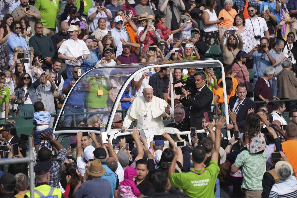 Pope Francis waves as he arrives to take part in a public mass at Commonwealth Stadium in Edmonton, Tuesday, July 26, 2022. (Nathan Denette/The Canadian Press via AP)