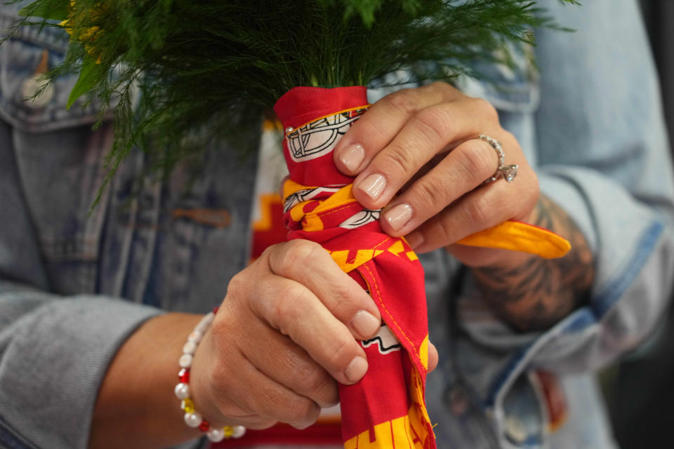 Brooke Myers' wedding bouquet featured a Kansas City Chiefs wrap. She also wore a friendship bracelet because she's a Taylor Swift fan.