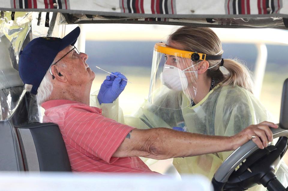 A resident of a long term care facility gets tested for the coronavirus with a nasal swab in The Villages, Florida, in March 2020.