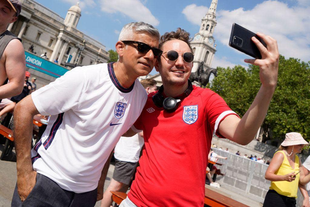 Sadiq Khan poses for a selfie-photograph as he joins England supporters celebrating England's victory at the fan zone in central London after watching the football UEFA EURO 2020 match between England and Croatia