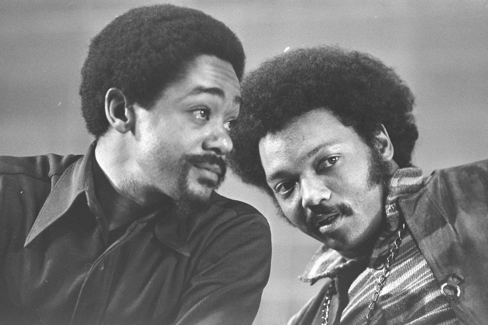 FILE - In this March 12, 1972, file photo, Bobby Seale, left, and the Rev. Jesse Jackson talk at the National Black Political Convention in Gary, Ind. Thousands of Black activists from across the U.S. will hold the 2020 Black National Convention on Aug. 28, 2020, via livestream to produce a new political agenda that builds on the protests that followed George Floyd’s death. Convention organizers said this year’s event will pay tribute to the historic 1972 National Black Political Convention. (AP Photo/File)