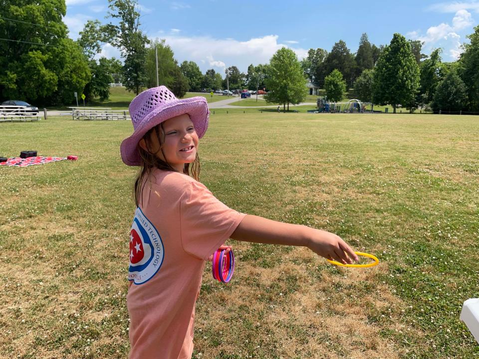 Abbey Murphy, 7, plays Ring Toss after a trip to the Splash Pad at the first Spring Lawn Games Festival held at Carl Cowan Park Sunday, May 22, 2022.