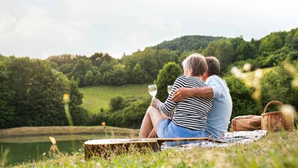 Senior couple at the lake having a picnic