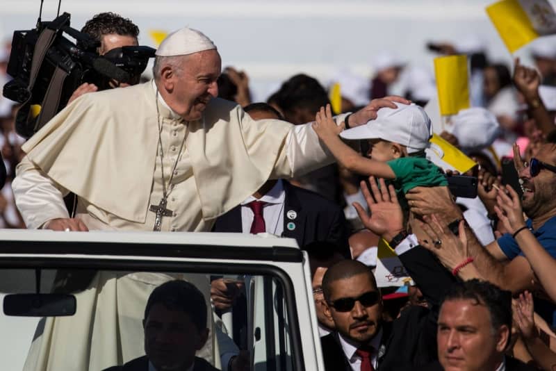 Pope Francis greets people upon his arrival to lead a mass at the Zayed Sports City Stadium. Gehad Hamdy/dpa