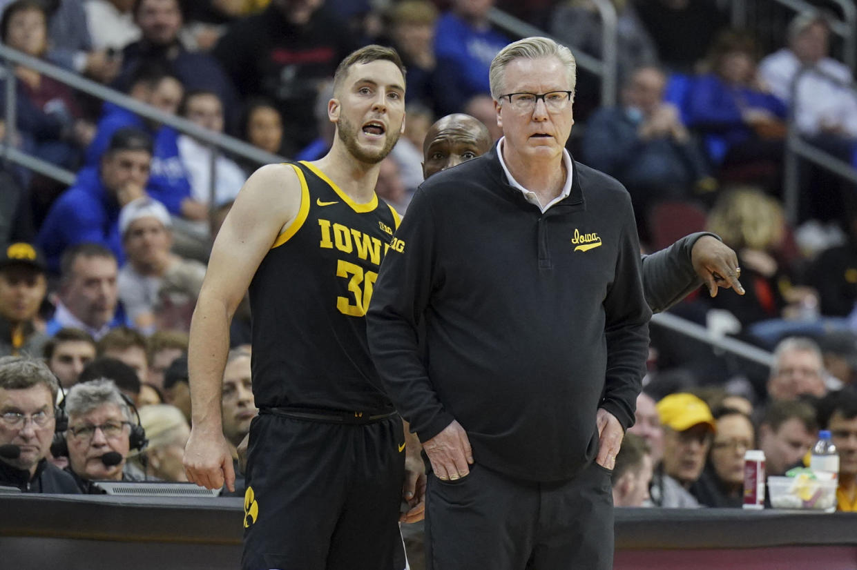 Connor McCaffery of the Iowa Hawkeyes talks to his head coach and father, Fran McCaffery, during the game against the Seton Hall Pirates at Prudential Center on Nov. 16, 2022 in Newark, NJ.  (Porter Binks / Getty Images)