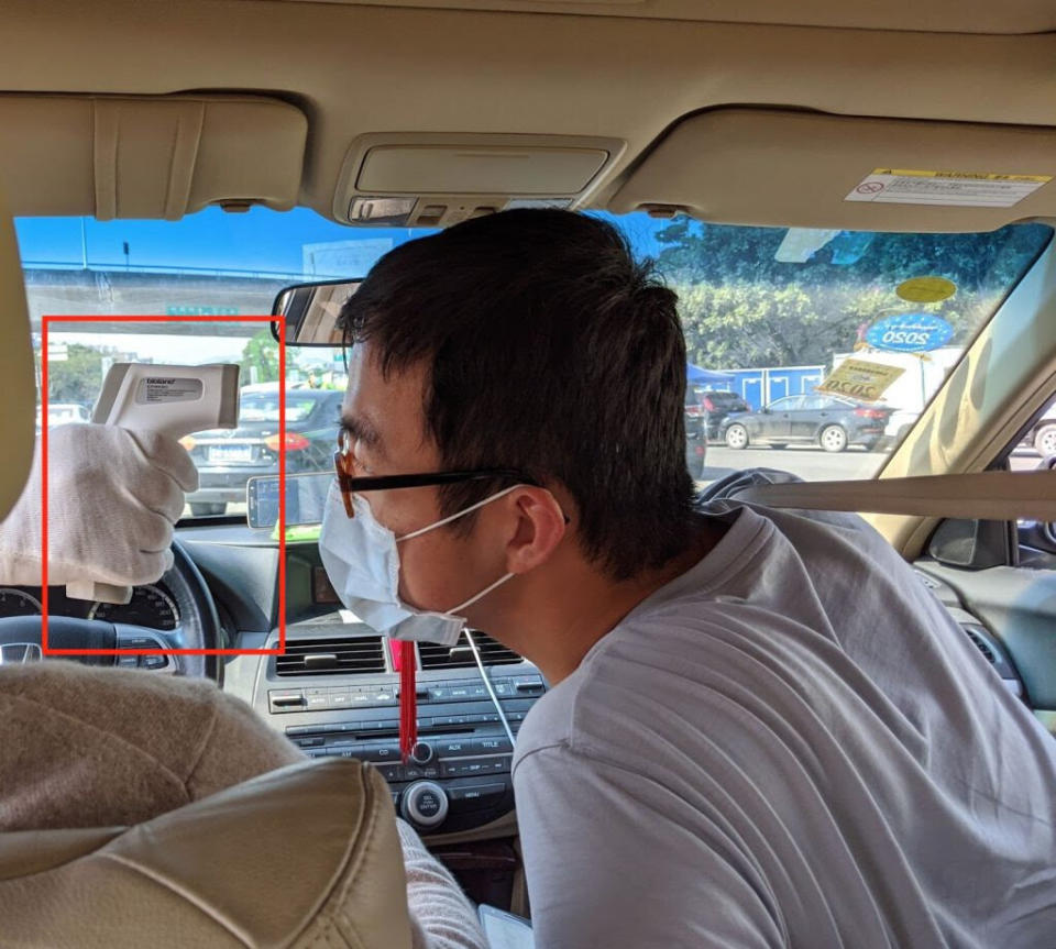 Harry on the receiving end of a thermometer gun at a highway toll booth. (Photo: Courtesy of Peter Xu)