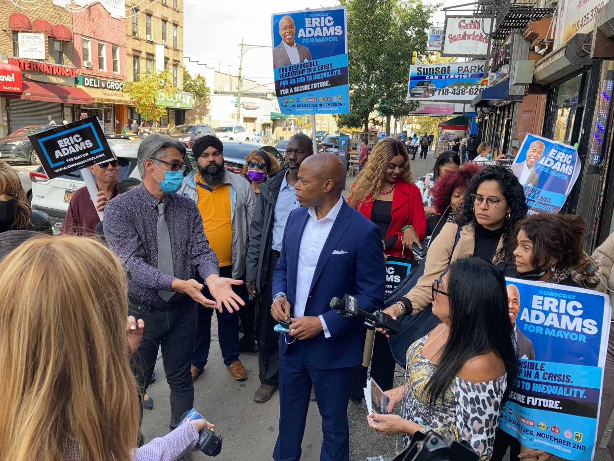 Democratic New York City mayoral candidate Eric Adams is surrounded by supporters in Sunset Park on Monday, Oct. 25, 2021 in Brooklyn, New York.