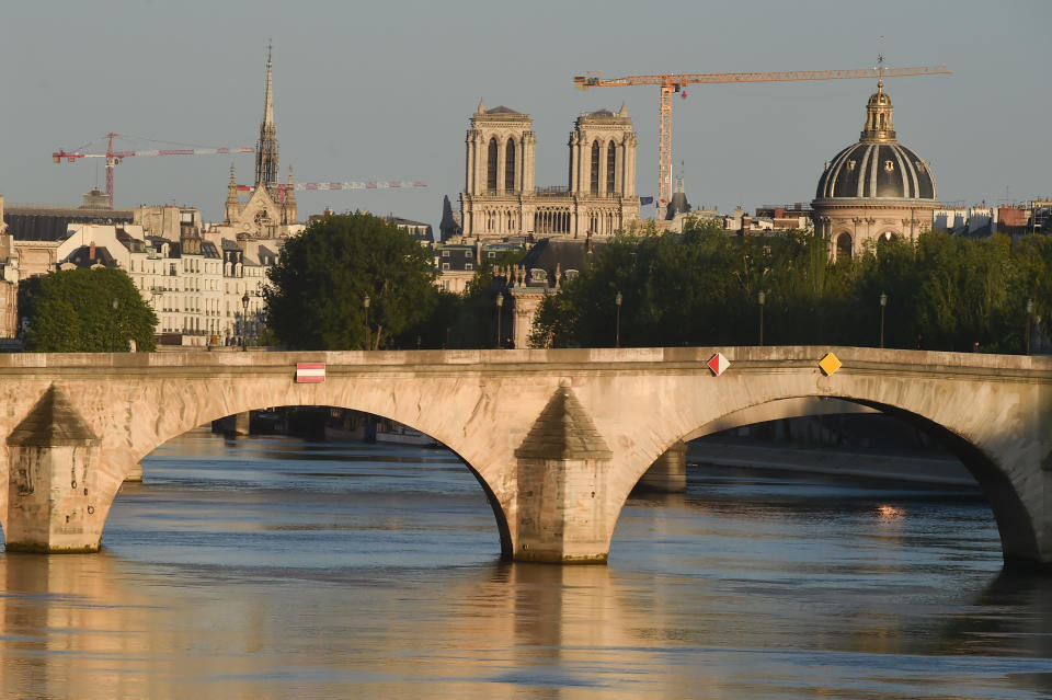 View of Pont du Carrousel and Notre-Dame de Paris Cathedral, which was damaged in a devastating fire one year ago, whose work has been stopped due to the coronavirus (COVID 19) outbreak as lockdown continues due to the coronavirus on April 14, 2020 in Paris, France. The coronavirus pandemic has spread to many countries across the world, claiming over 125,000 lives and infecting over 1.9 million people. (Photo by Stephane Cardinale - Corbis/Corbis via Getty Images)