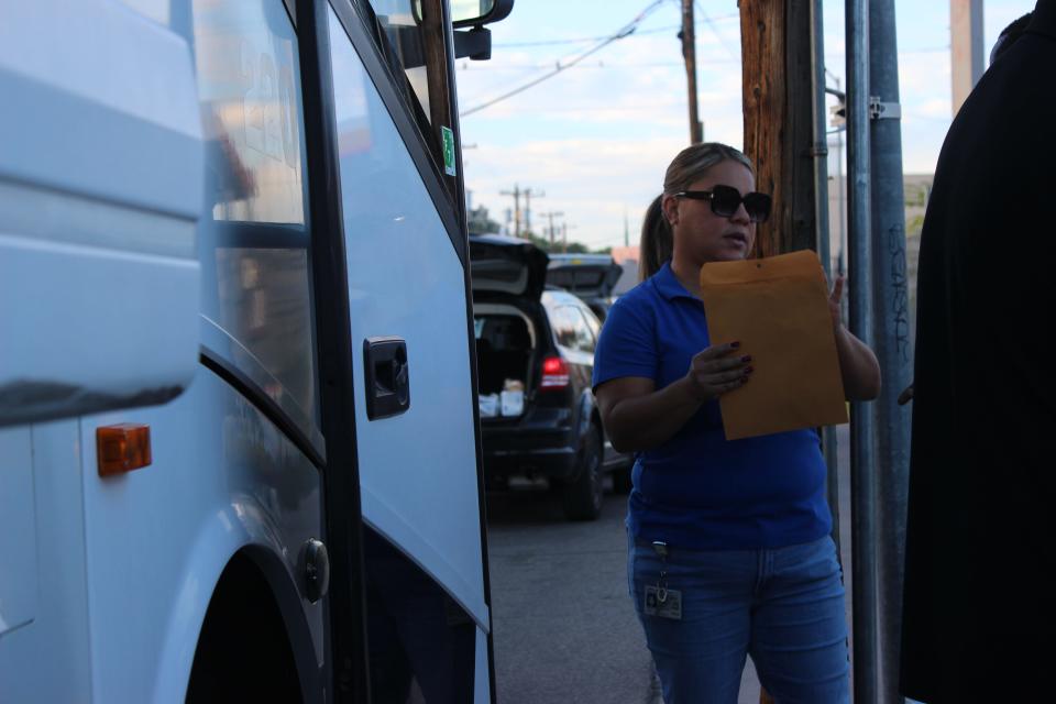 Alejandra Ceballos, health equity coordinator with Santa Cruz County Public Health Services, helps migrants  board a Pima County-funded bus headed for Phoenix after being released by Border Patrol into Nogales on Thursday, September 21, 2023.