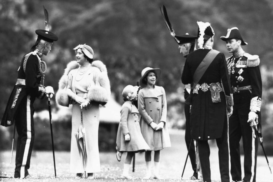 Looking upwards: Lord Elphinstone (left) speaks to Queen Elizabeth the Queen Mother, along with Princess Margaret, Princess Elizabeth and King George VI (far right), at Holyrood Palace in Edinburgh in July 1937 (Fox Photos/Hulton Archive/Getty Images)