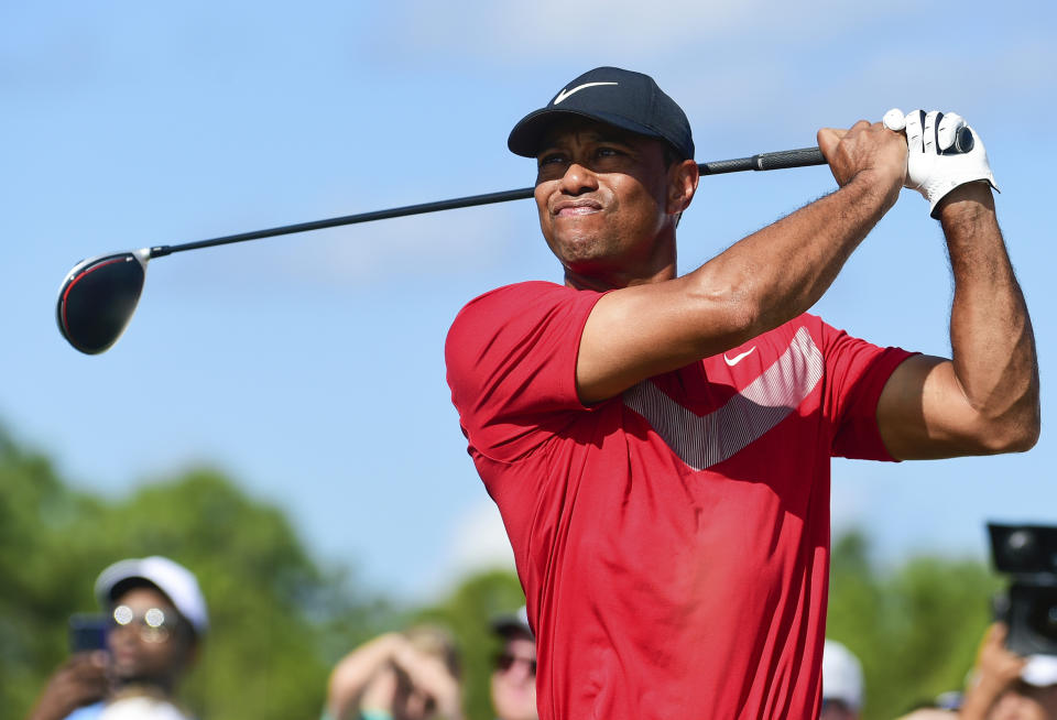 FILE - Tiger Woods follows his ball at the fourth tee during the last round of the Hero World Challenge at Albany Golf Club in Nassau, Bahamas, on Dec. 7, 2019. Woods is starting a new year with a new look. Just not a different color. Woods makes his 2024 debut this week in the Genesis Invitational at Riviera, a signature event on the PGA Tour in which he is the tournament host. The first order of business is unveiling what he referred to in December as the next “chapter.” (AP Photo/Dante Carrer, File)