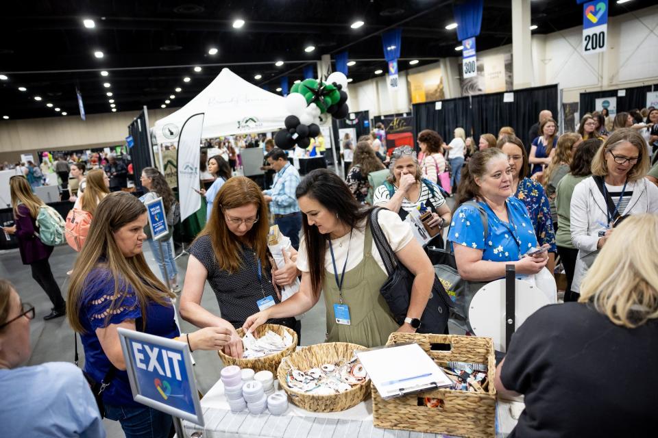 Attendees check out giveaways at the Show Up for Teachers Conference at the Mountain America Expo Center in Sandy on Wednesday, July 19, 2023. | Spenser Heaps, Deseret News