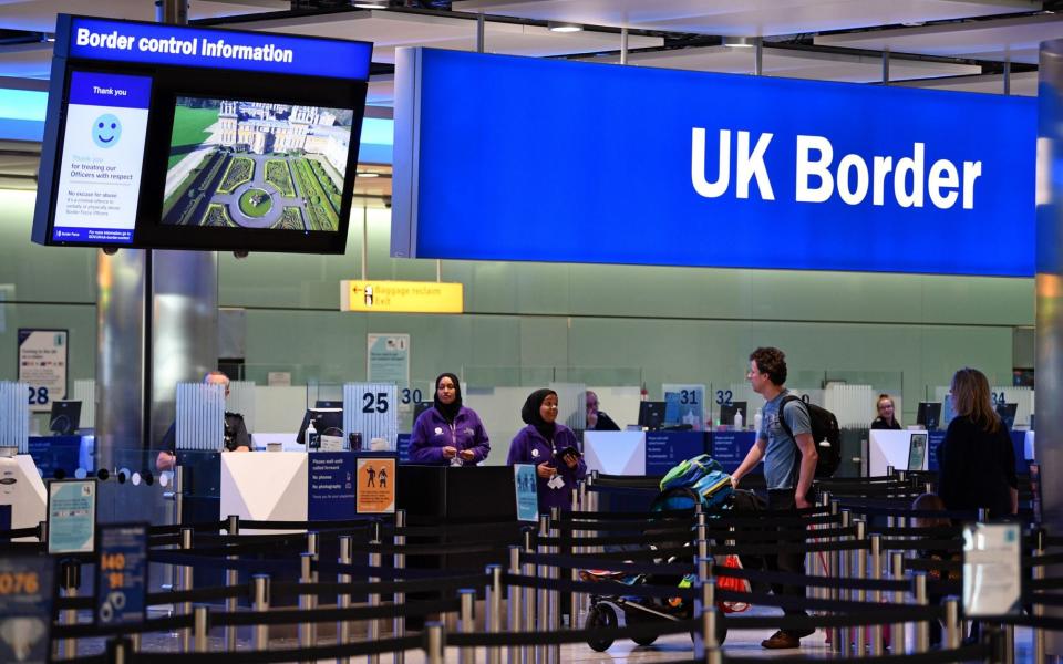 Passengers arrive at passport control in Terminal 2 at Heathrow Airport in London 