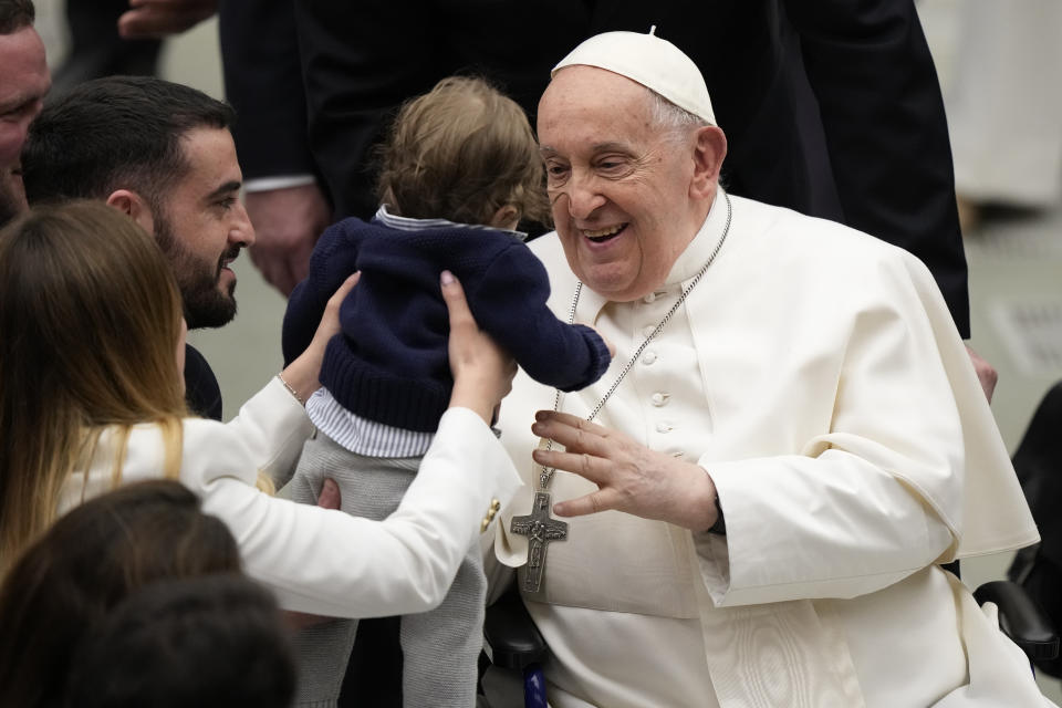 Pope Francis hugs a baby at the end of his weekly general audience in the Paul VI Hall, at the Vatican, Wednesday, Feb. 28, 2024. (AP Photo/Andrew Medichini)