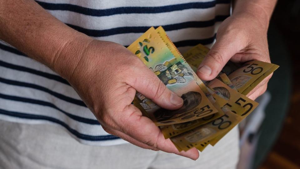 man counting $50 notes