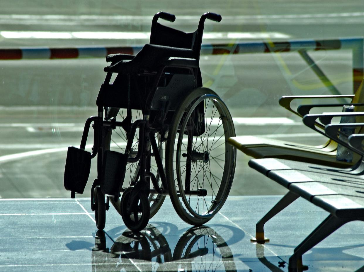 An empty wheelchair in an airport.