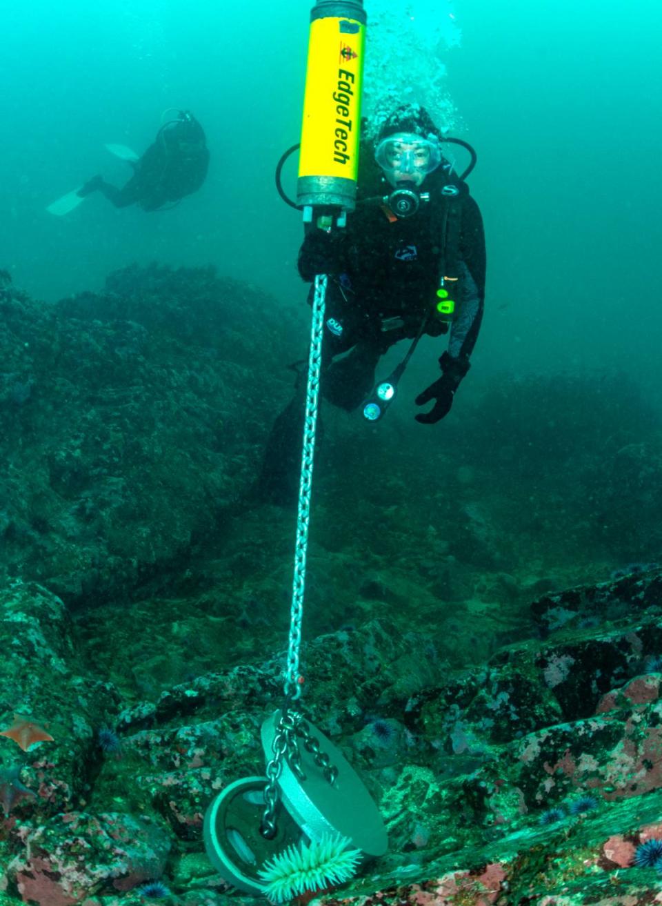 NOAA science diver Lindsey Peavey Reeves inspects the lower half of the soundscape mooring in place in 20 meters of water on July 12, 2023, off Point Estero. The NOAA Office of National Marine Sanctuaries and partners are listening to underwater sound inside the proposed Chumash Heritage National Marine Sanctuary.