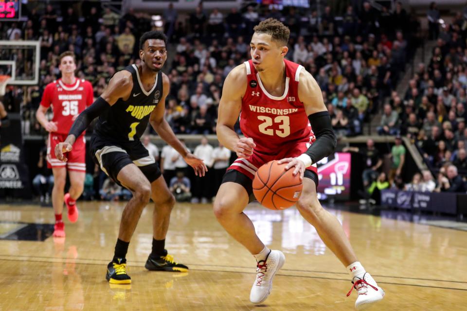 Wisconsin guard Kobe King (23) drives on Purdue forward Aaron Wheeler (1) during the first half of an NCAA college basketball game in West Lafayette, Ind., Friday, Jan. 24, 2020. (AP Photo/Michael Conroy)