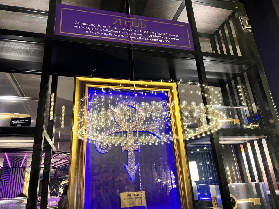 A display for The O2's 21 Club with a framed Prince logo.