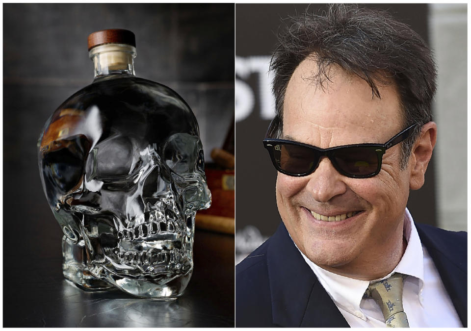 This combination photo shows actor and businessman Dan Aykroyd at the Los Angeles premiere of "Ghostbusters" on July 9, 2016, right, and a bottle of his Crystal Head Vodka. (Crystal Head Vodka via AP, left, and AP Photo)