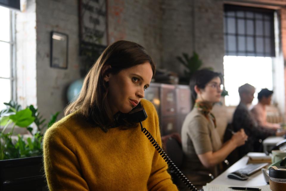 felicity jones as ellie haworth in the last letter from your lover, in a newsroom taking phone call