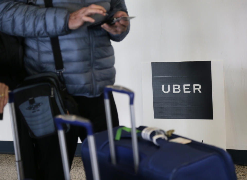 FILE - In this March 15, 2017, file photo, a traveler tries to book a ride with Uber at LaGuardia Airport in New York. Uber is providing a look under the hood of its business in the lead-up to its hotly anticipated debut on the stock market. Documents released Thursday, April 11, 2019, offered the most detailed view of the world’s largest ride-hailing service since its inception a decade ago. (AP Photo/Seth Wenig, File)