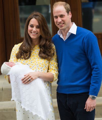 <p>Samir Hussein/WireImage</p> Kate Middleton and Prince William holding Princess Charlotte outside St. Mary's Hospital on May 2, 2015