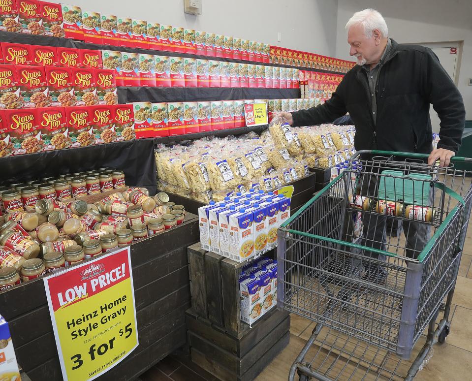 Acme Fresh Market customer Jim Cooper picks up side dish items for his Thanksgiving table Monday in Fairlawn.