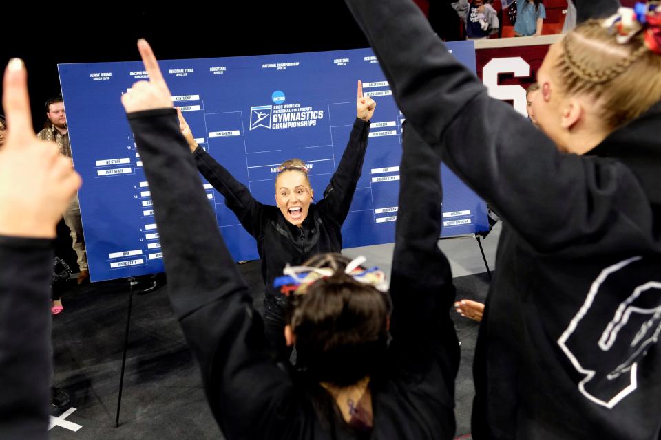 OU's Olivia Trautman celebrates after putting the Sooners' sticker on the NCAA bracket after winning an NCAA Regional final on Saturday at Lloyd Noble Center in Norman.