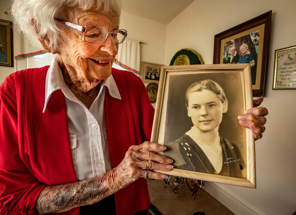 Lenore "Gundy" Costello holds her high school graduation photo. She will celebrate her 107th birthday on Sunday.