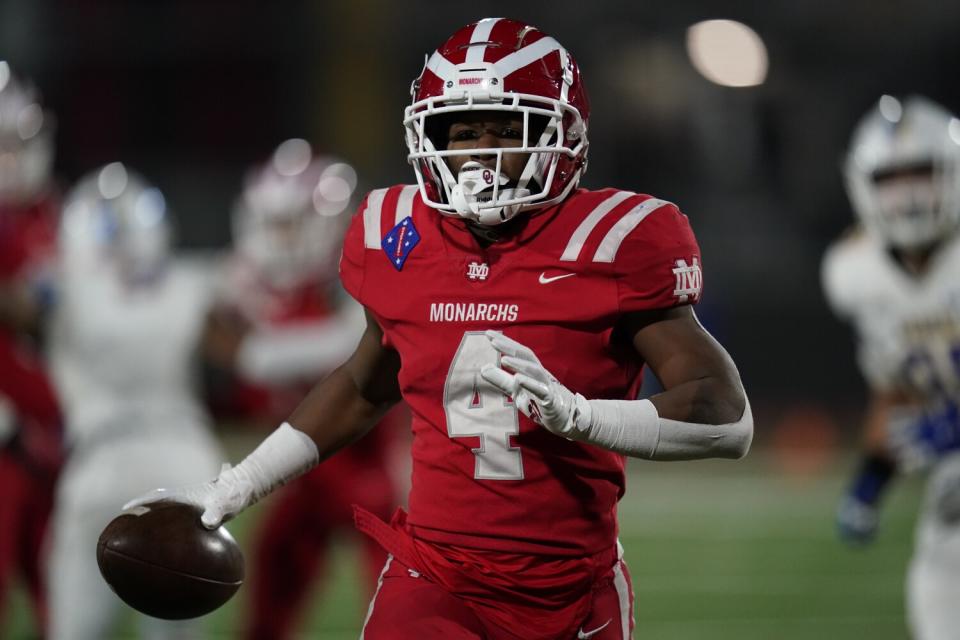 Former Mater Dei running back Raleek Brown carries the ball on the field.