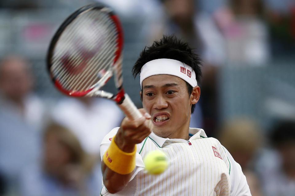 Kei Nishikori from Japan returns the ball during a Madrid Open tennis tournament final match against Rafael Nadal from Spain in Madrid, Spain, Sunday, May 11, 2014. (AP Photo/Andres Kudacki)