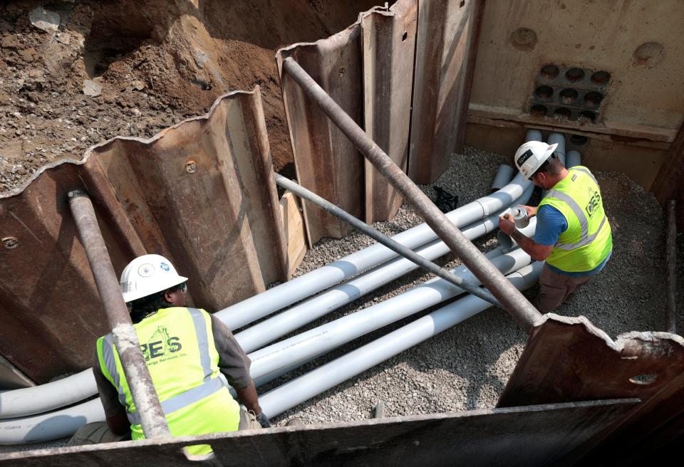 Work goes on laying new pipe and underground electrical near the Wayne State University campus area in Detroit on July 25, 2023.