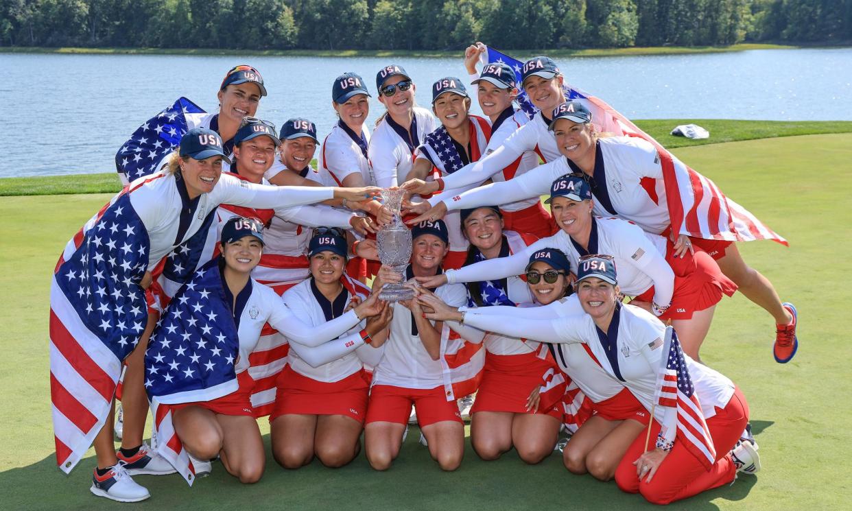 <span>The US team and captain Stacy Lewis pose with the Solheim Cup after their win against Europe.</span><span>Photograph: David Cannon/Getty Images</span>