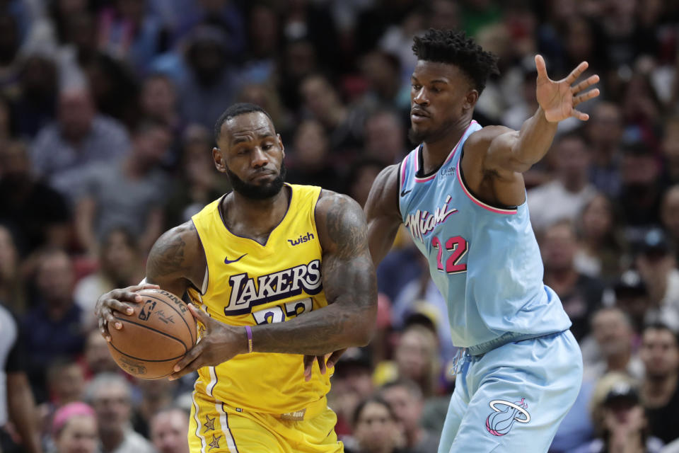 Miami Heat forward Jimmy Butler (22) defends Los Angeles Lakers forward LeBron James in a regular-season game. (AP Photo/Lynne Sladky)